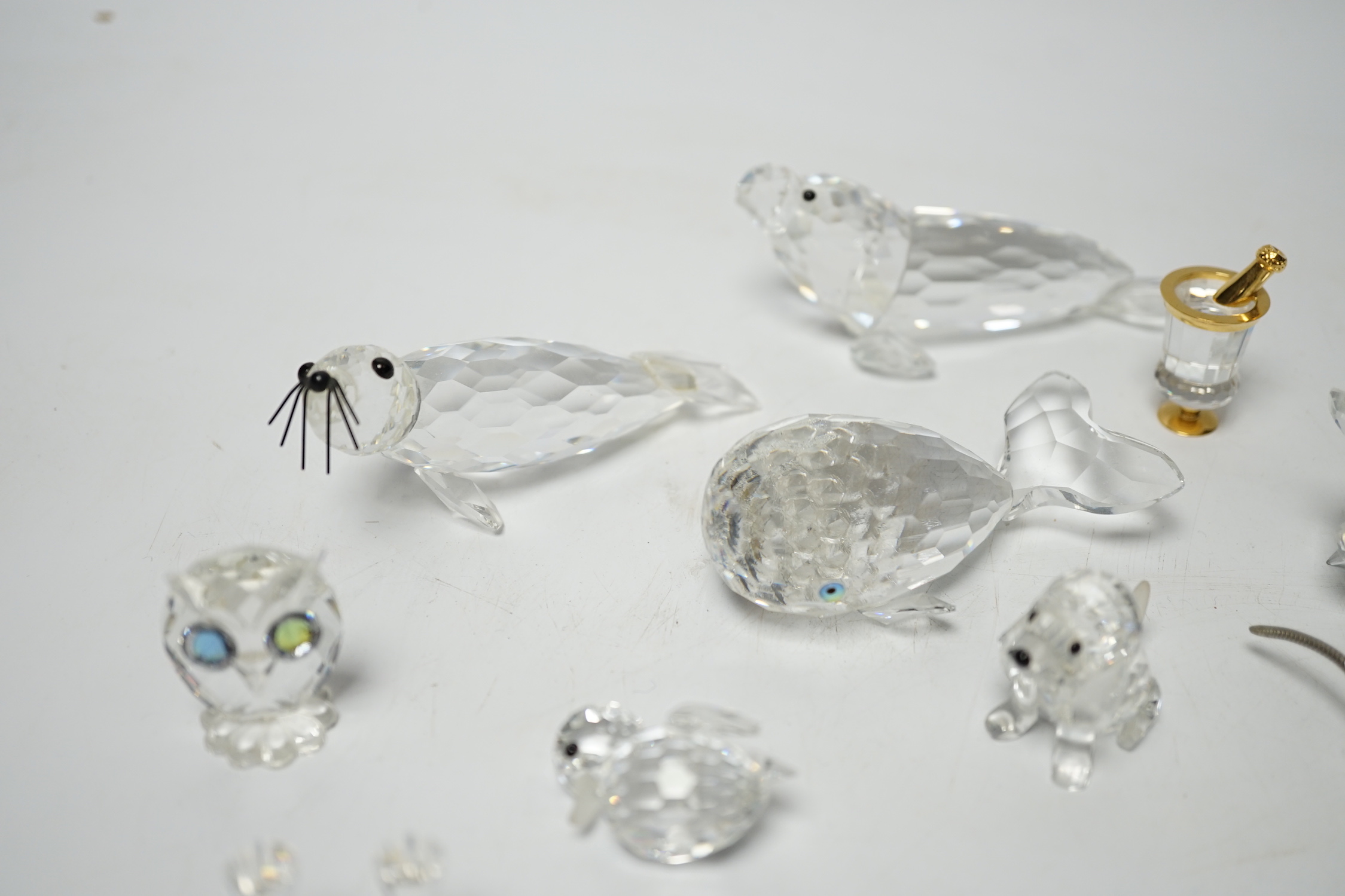 Eight Swarovski crystal animal ornaments and a miniature set of a Champagne cooler and two Champagne glass flutes, (11)